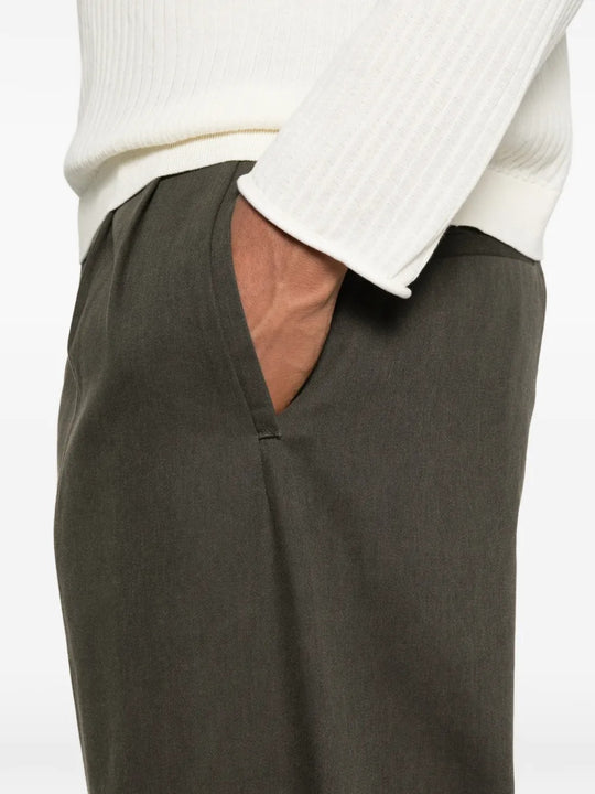 Close up of green pants, showing texture of the cotton fabric