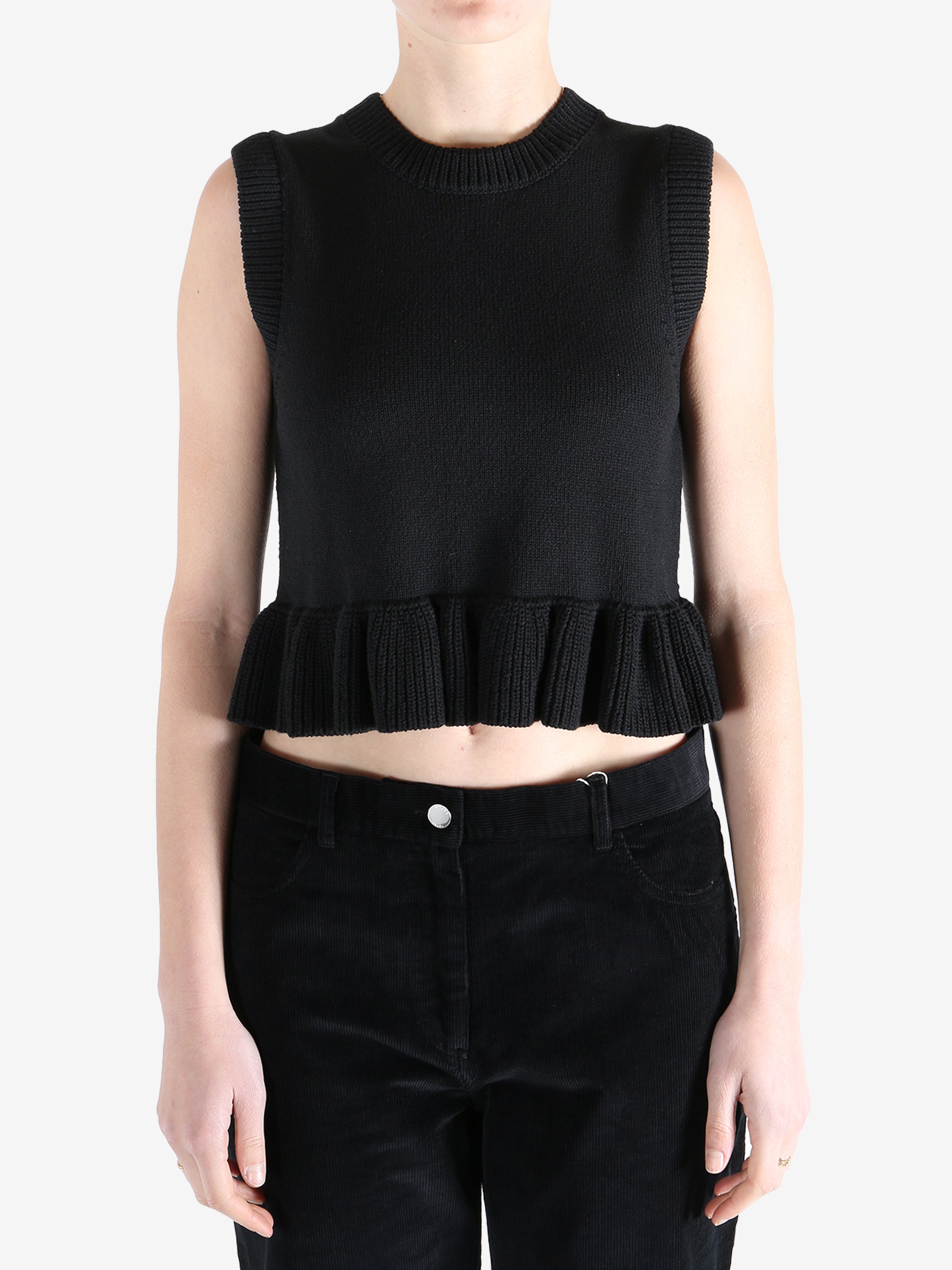 Black top worn by a person, showing the top's fit