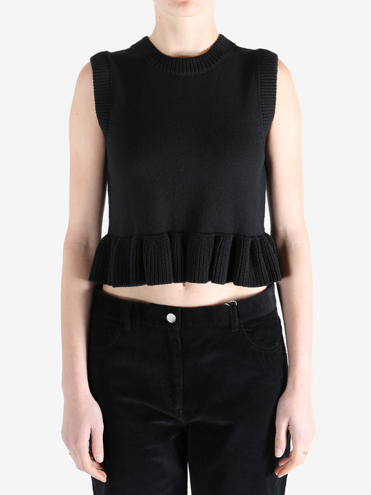 Black top worn by a person, showing the top's fit