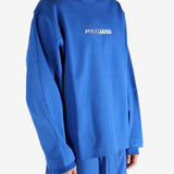 Blue sweatshirt worn by a person, showing the shirt's fit
