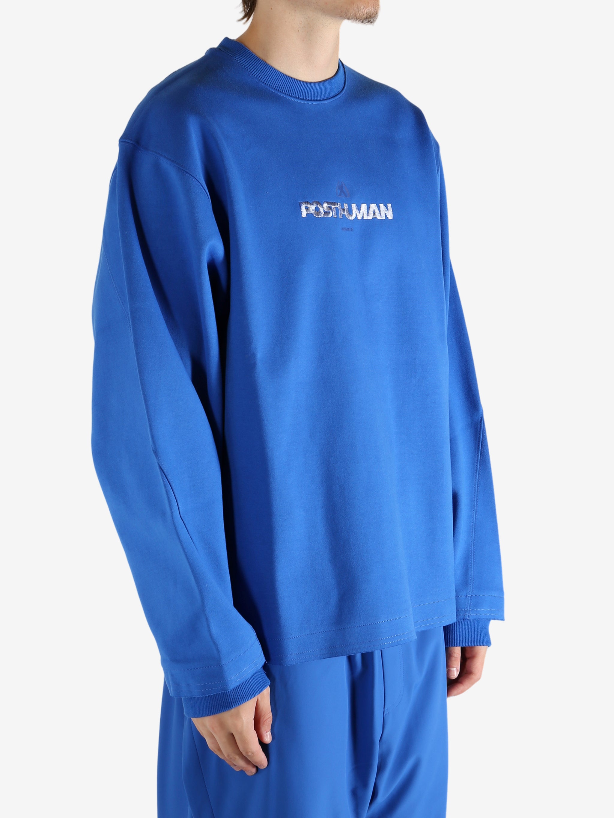 Blue sweatshirt worn by a person, showing the shirt's fit