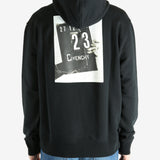 Black hoodie worn by a person, showing the hoodie's fit