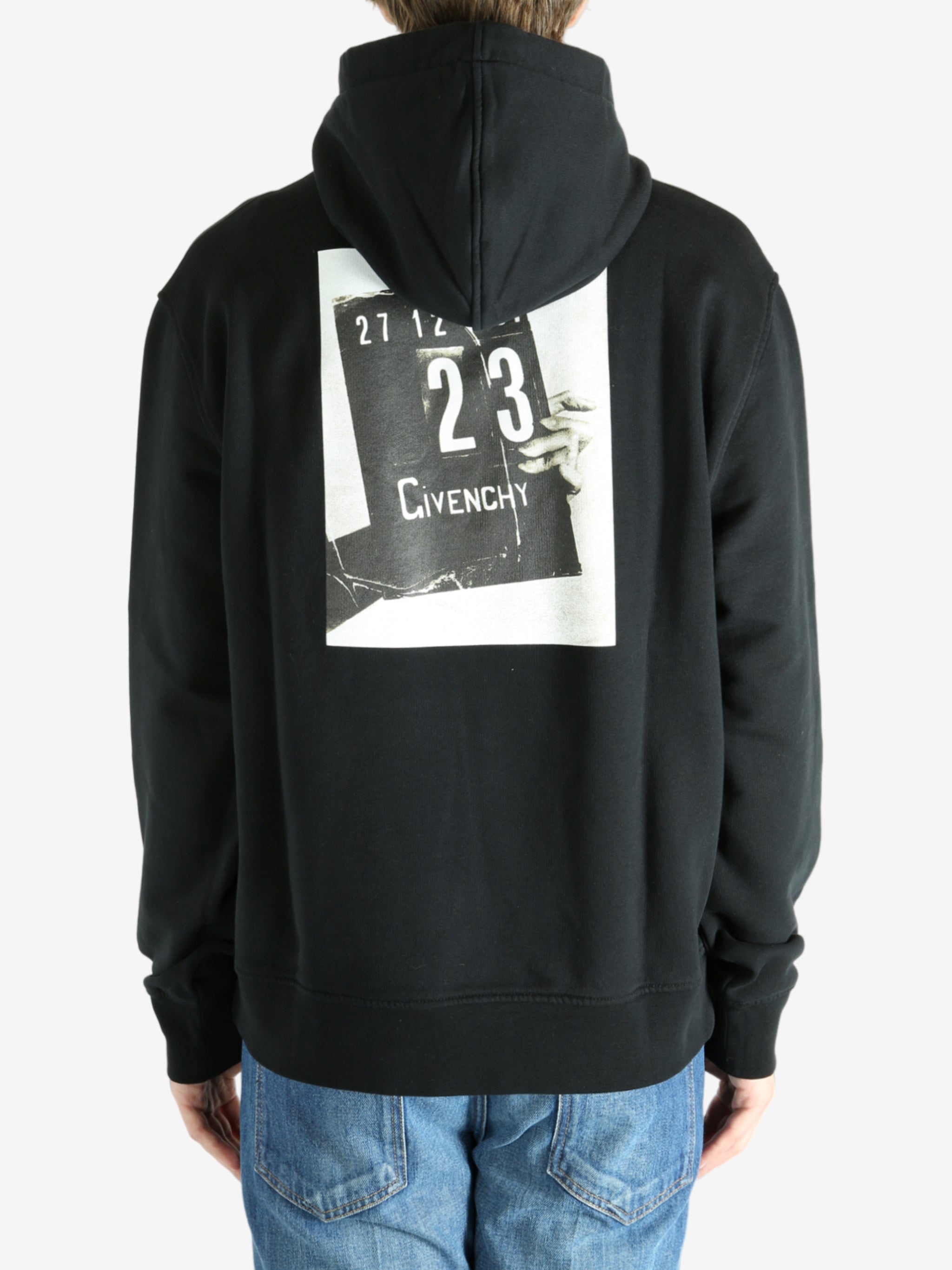 Black hoodie worn by a person, showing the hoodie's fit