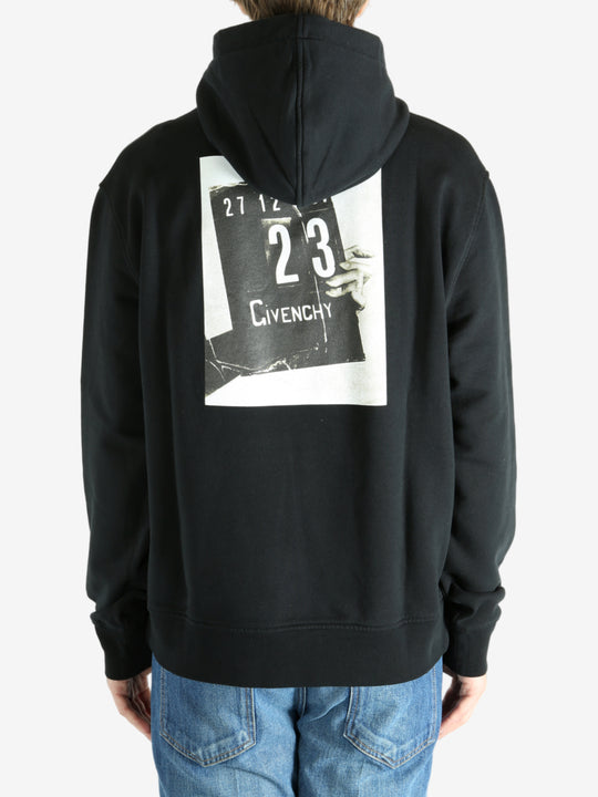 Black hoodie worn by a person, showing the hoodie's fit