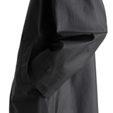 Close up of black jacket, showing the detail of the cotton material