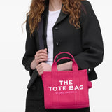 Pink bag carried by a person, showing the bag's size