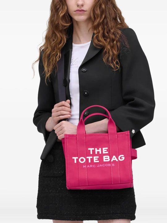 Pink bag carried by a person, showing the bag's size