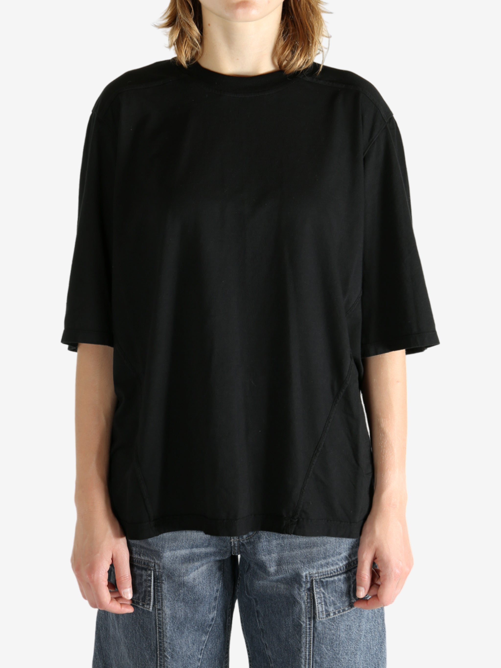 Black t-shirt worn by a person, showing the shirt's fit