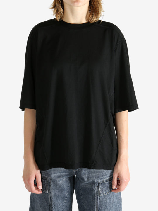Black t-shirt worn by a person, showing the shirt's fit