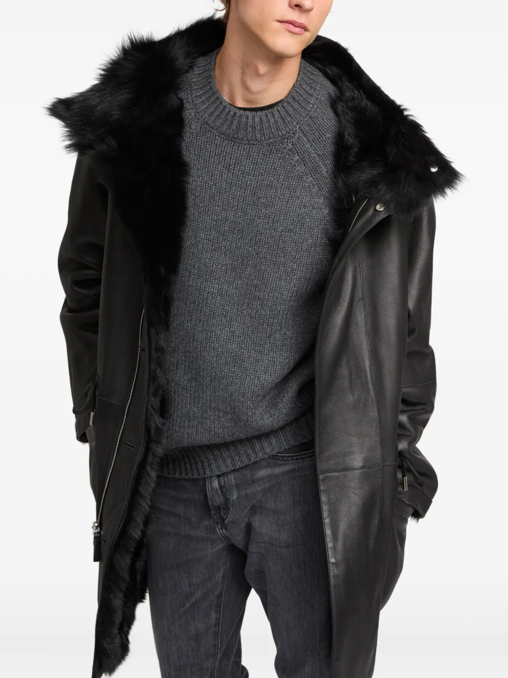 Black coat worn by a person, showing the coat's fit