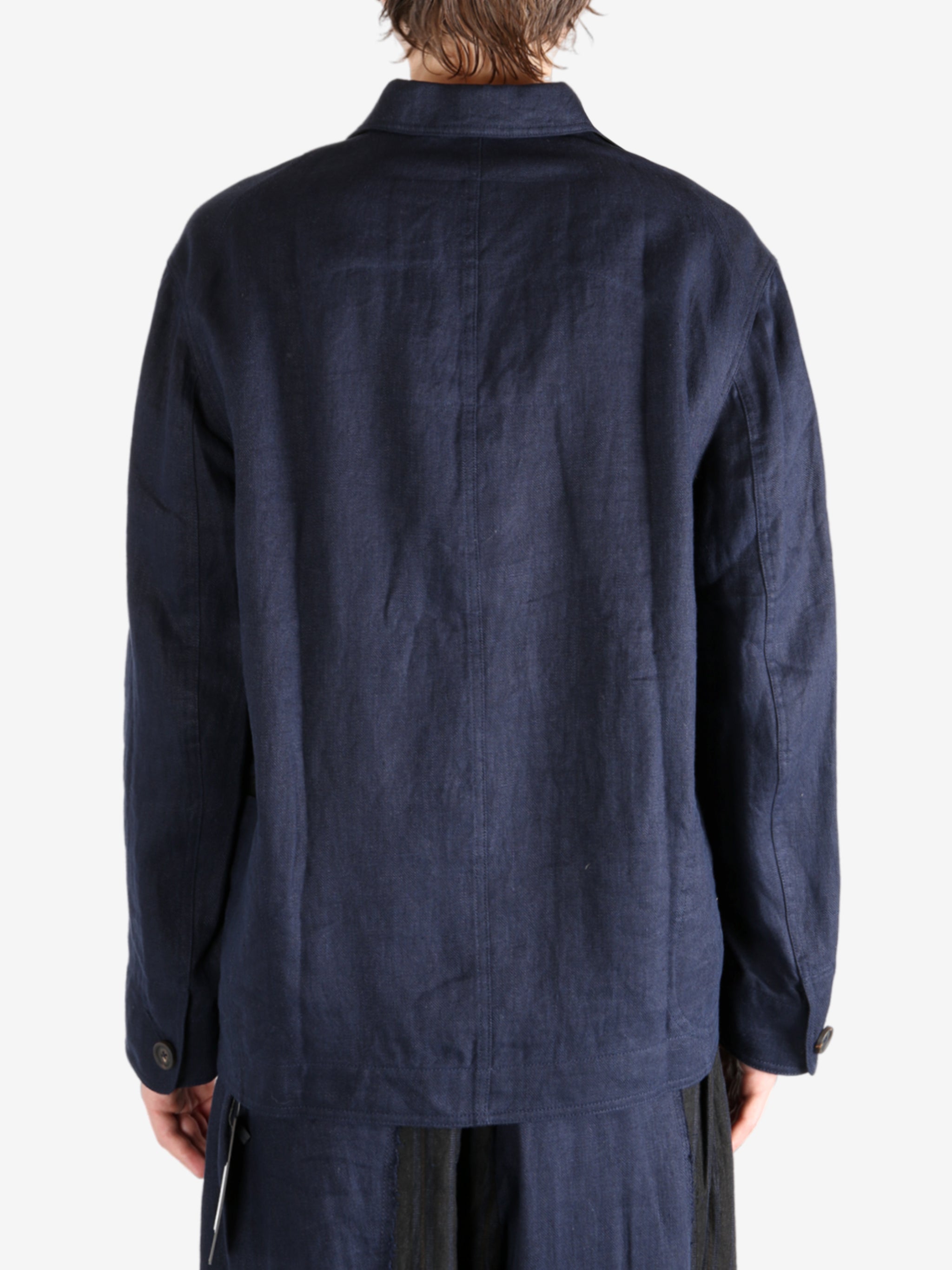 Blue jacket worn by a person, showing the jacket fit