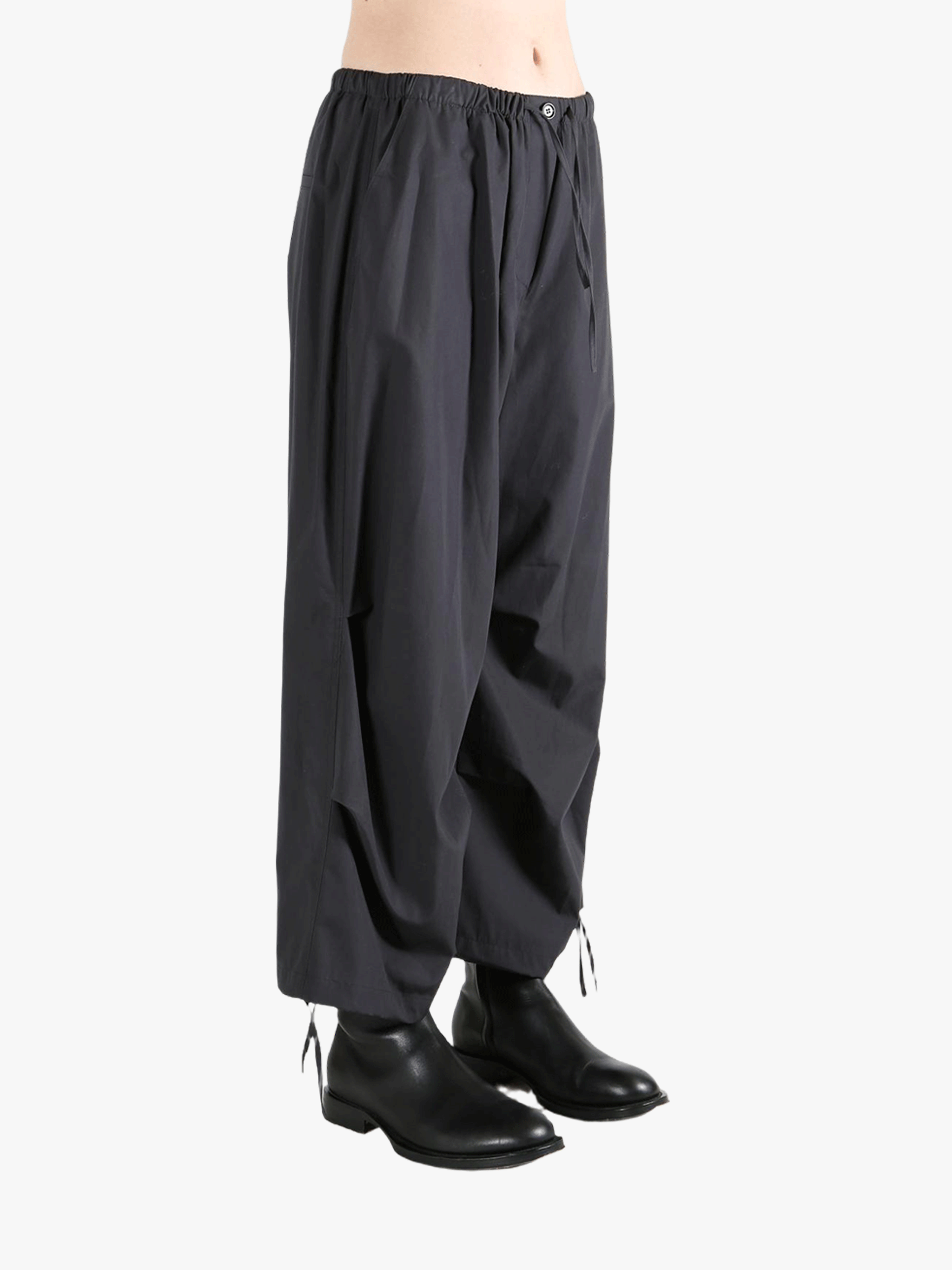 Black pants worn by a person, showing the pants' fit