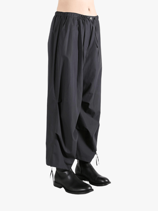 Black pants worn by a person, showing the pants' fit