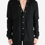 Black shirt worn by a person, showing the shirt's fit