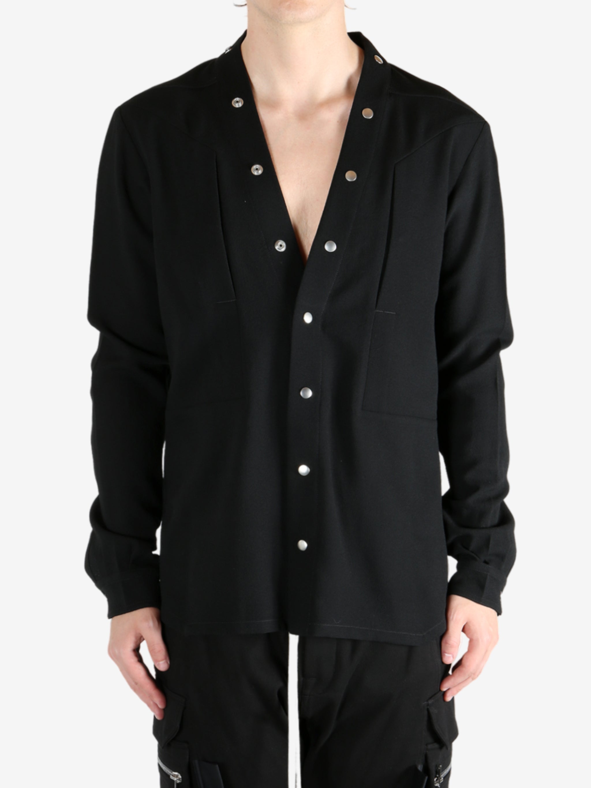 Black shirt worn by a person, showing the shirt's fit