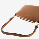 Close up of the brown bag, showing texture of the leather fabric