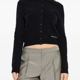 black knitwear worn by a person, showing the knitwear fit