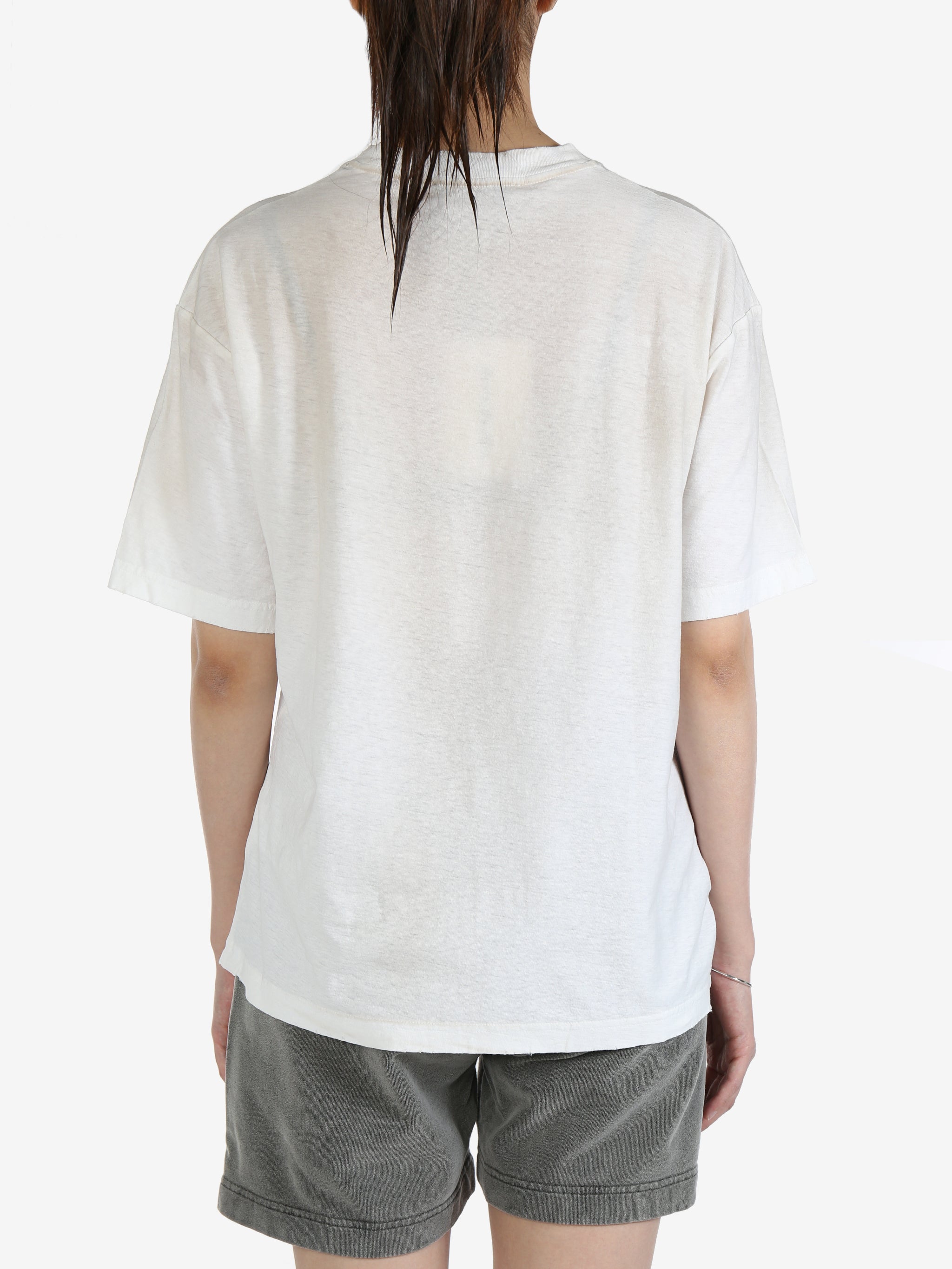White t-shirt worn by a person, showing the t-shirt's fit