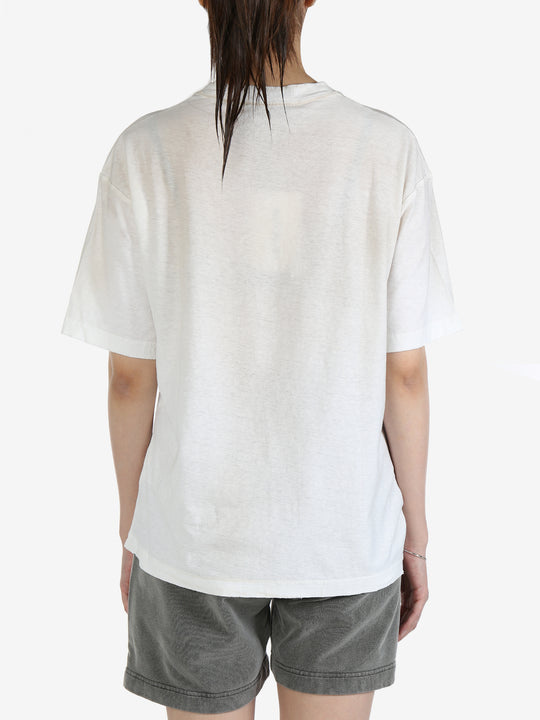 White t-shirt worn by a person, showing the t-shirt's fit