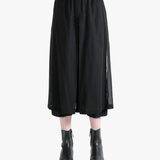 Black pants worn by a person, showing the pants fit