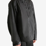 Black jacket worn by person, showing the jacket's fit