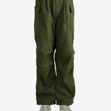 Green pants worn by a person, showing the pant’s fit