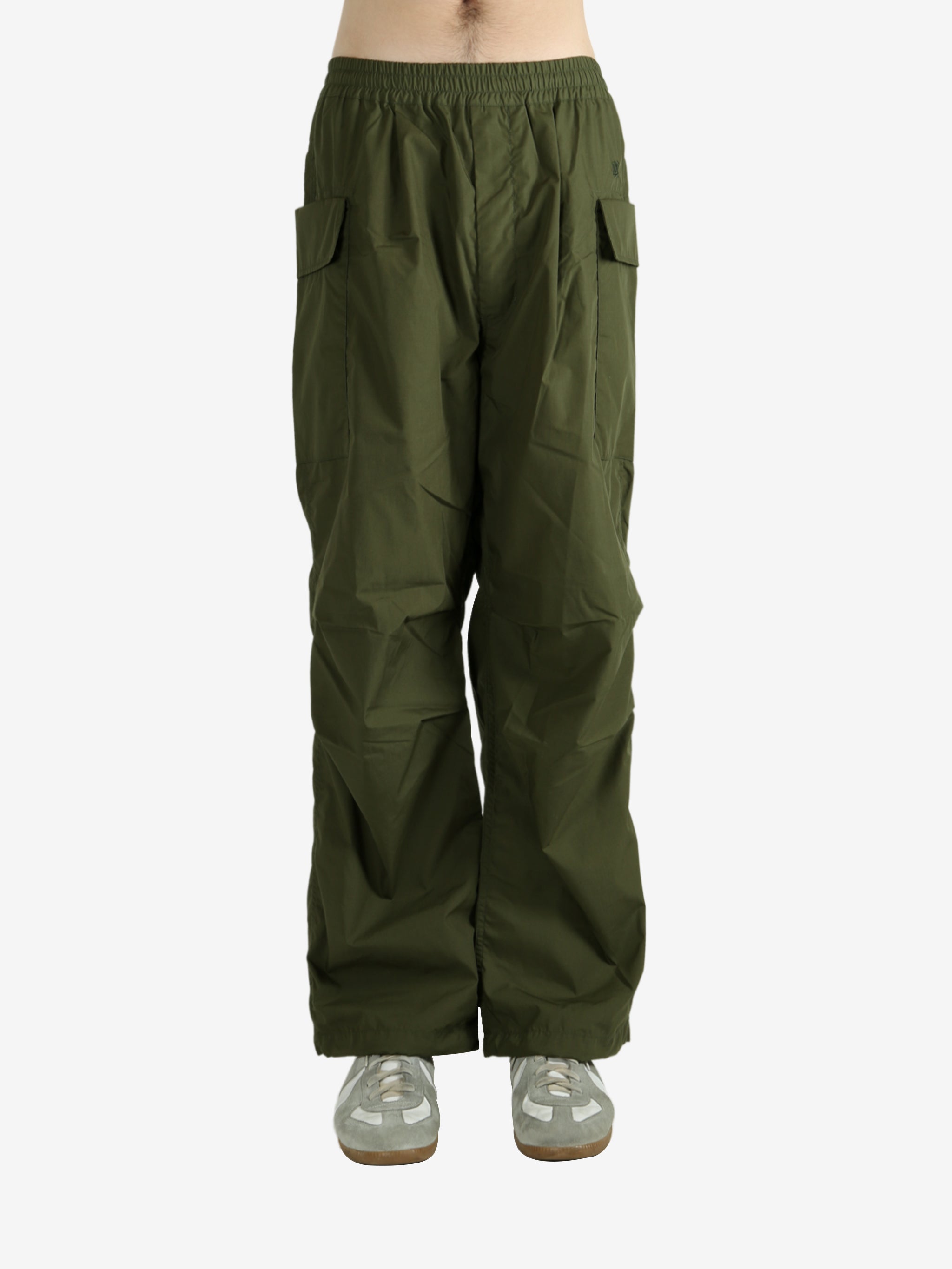 Green pants worn by a person, showing the pant’s fit