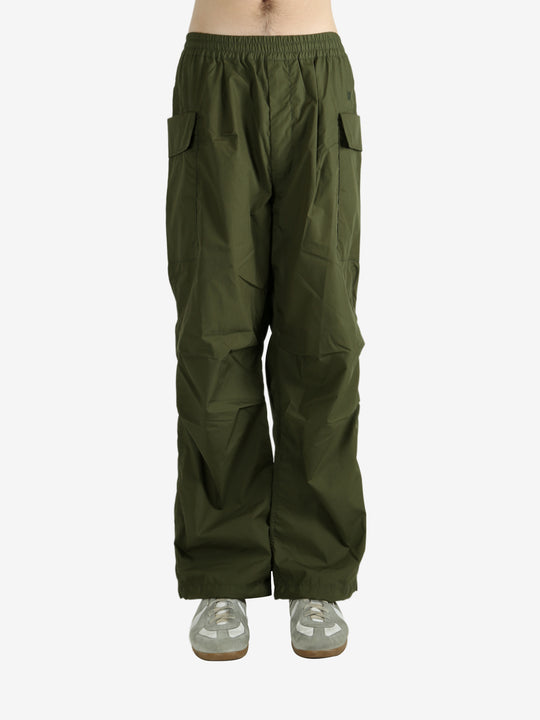 Green pants worn by a person, showing the pant’s fit