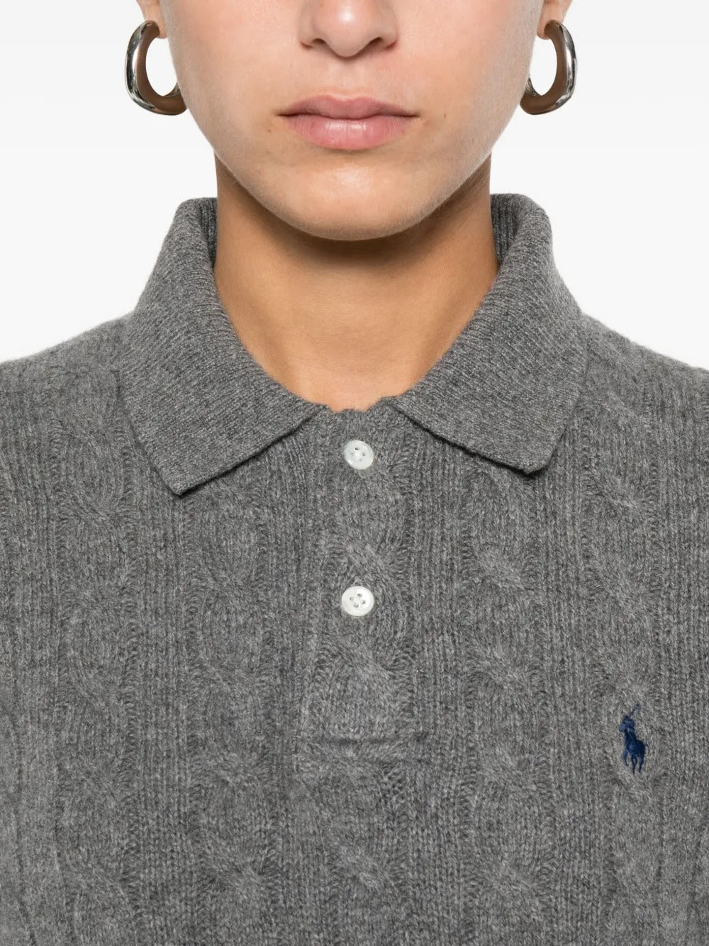 Close up of the grey knitwear, showing texture of the wool fabric