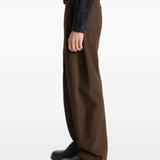 Brown pants worn by a person, showing the pants fit