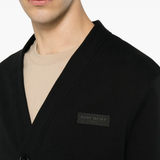 Close up of the black knitwear, showing texture of the cotton
