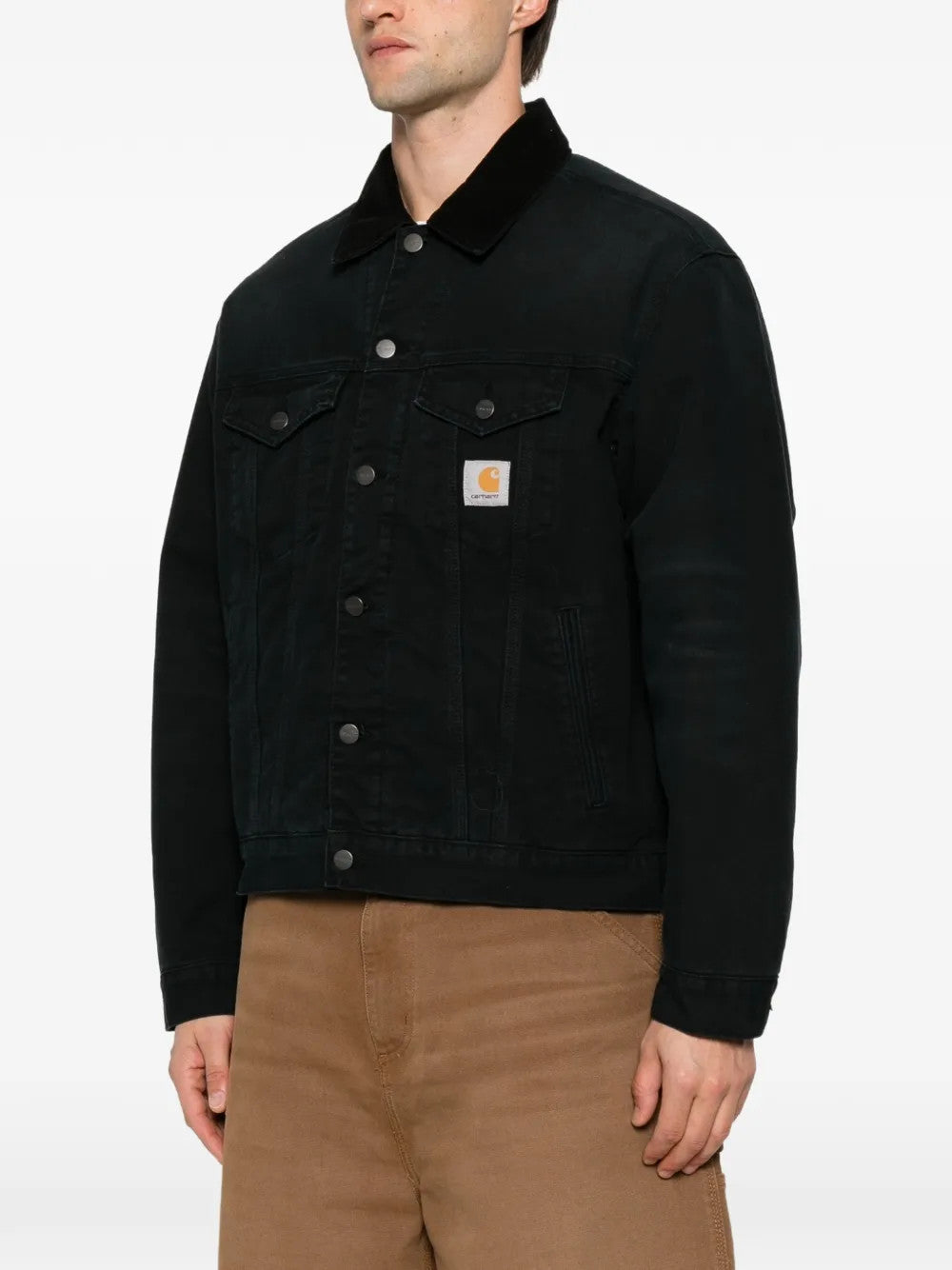 Black jacket worn by a person, showing the jacket fit
