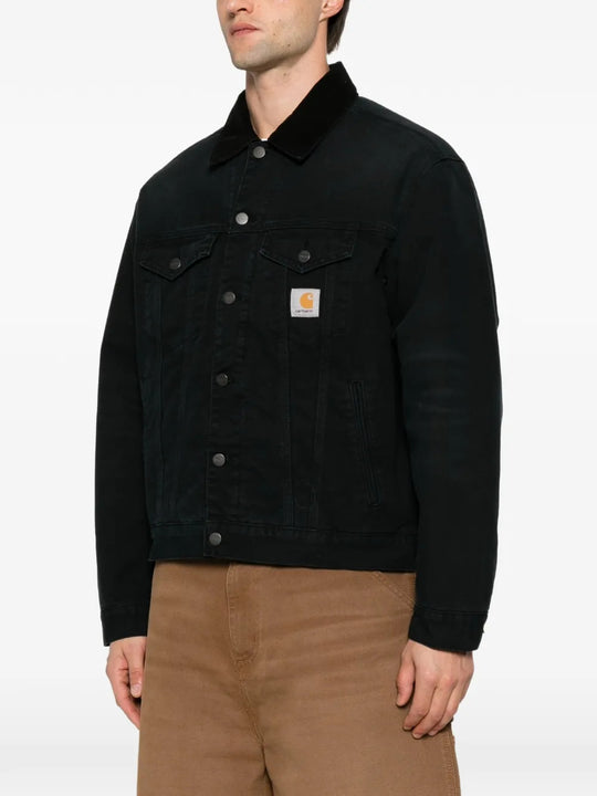 Black jacket worn by a person, showing the jacket fit