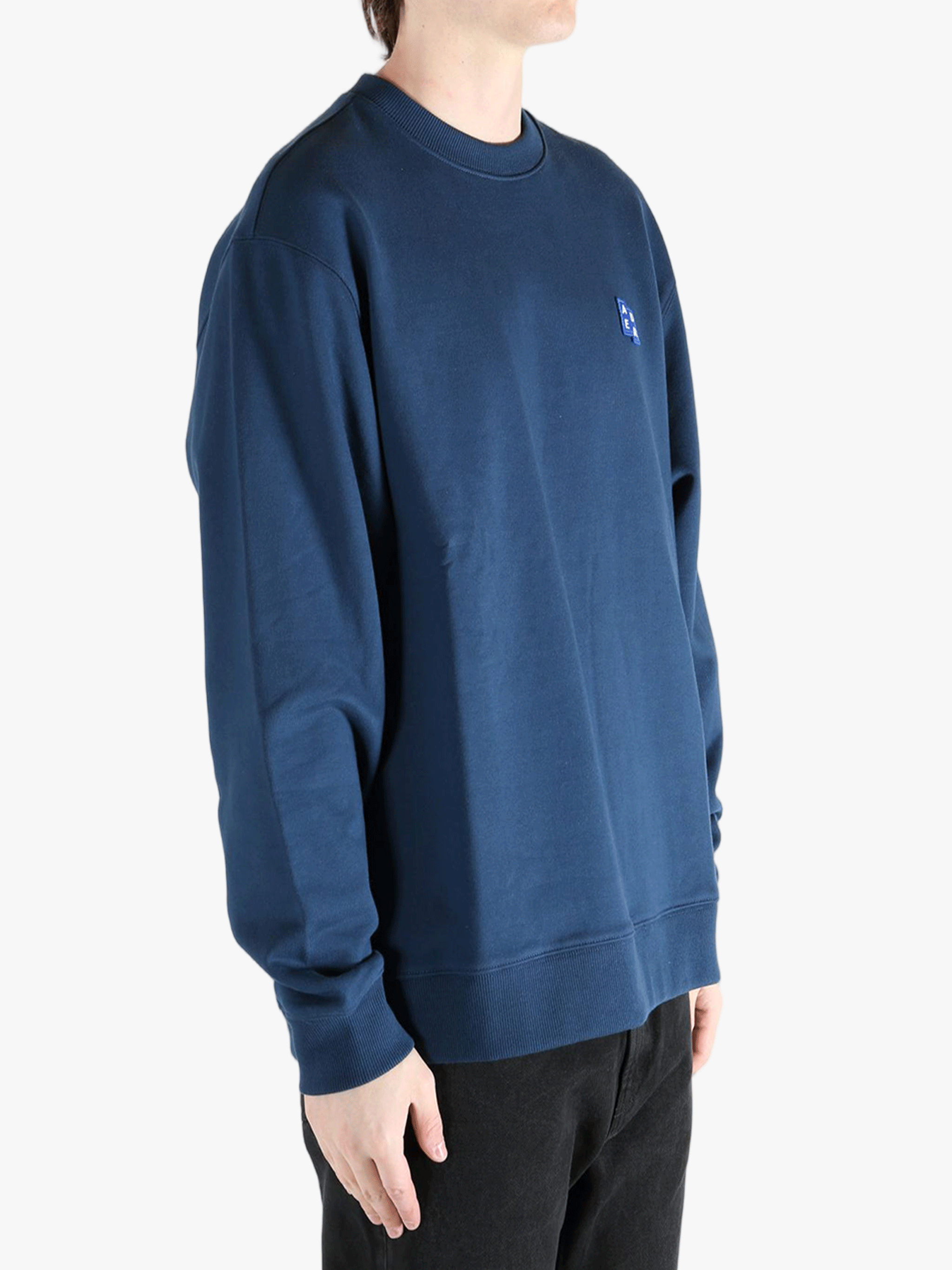 Navy sweater worn by a person, showing the sweater's fit