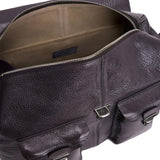 Close up of purple bags, showing texture of the leather fabric