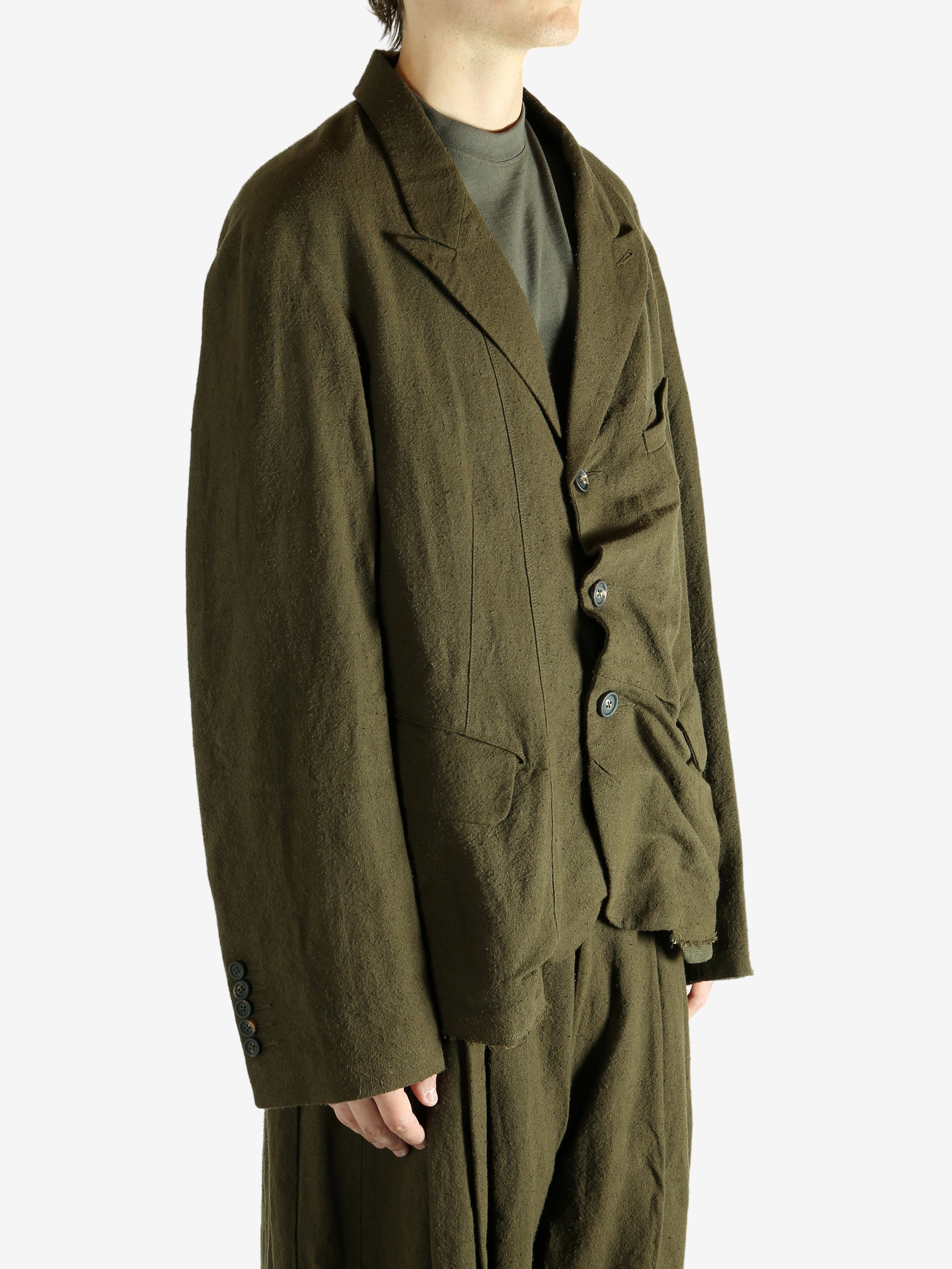 Green blazer worn by a person, showing the blazer's fit