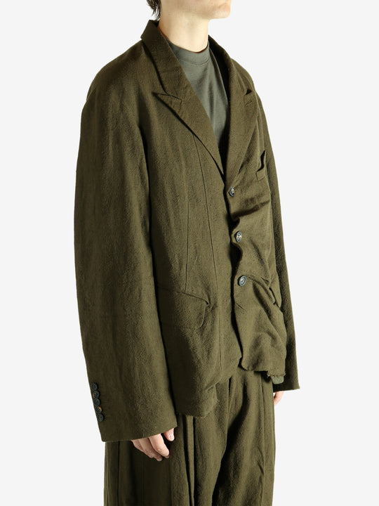 Green blazer worn by a person, showing the blazer's fit