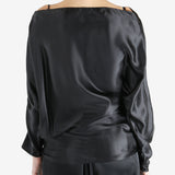 Black top worn by a person, showing the top's fit