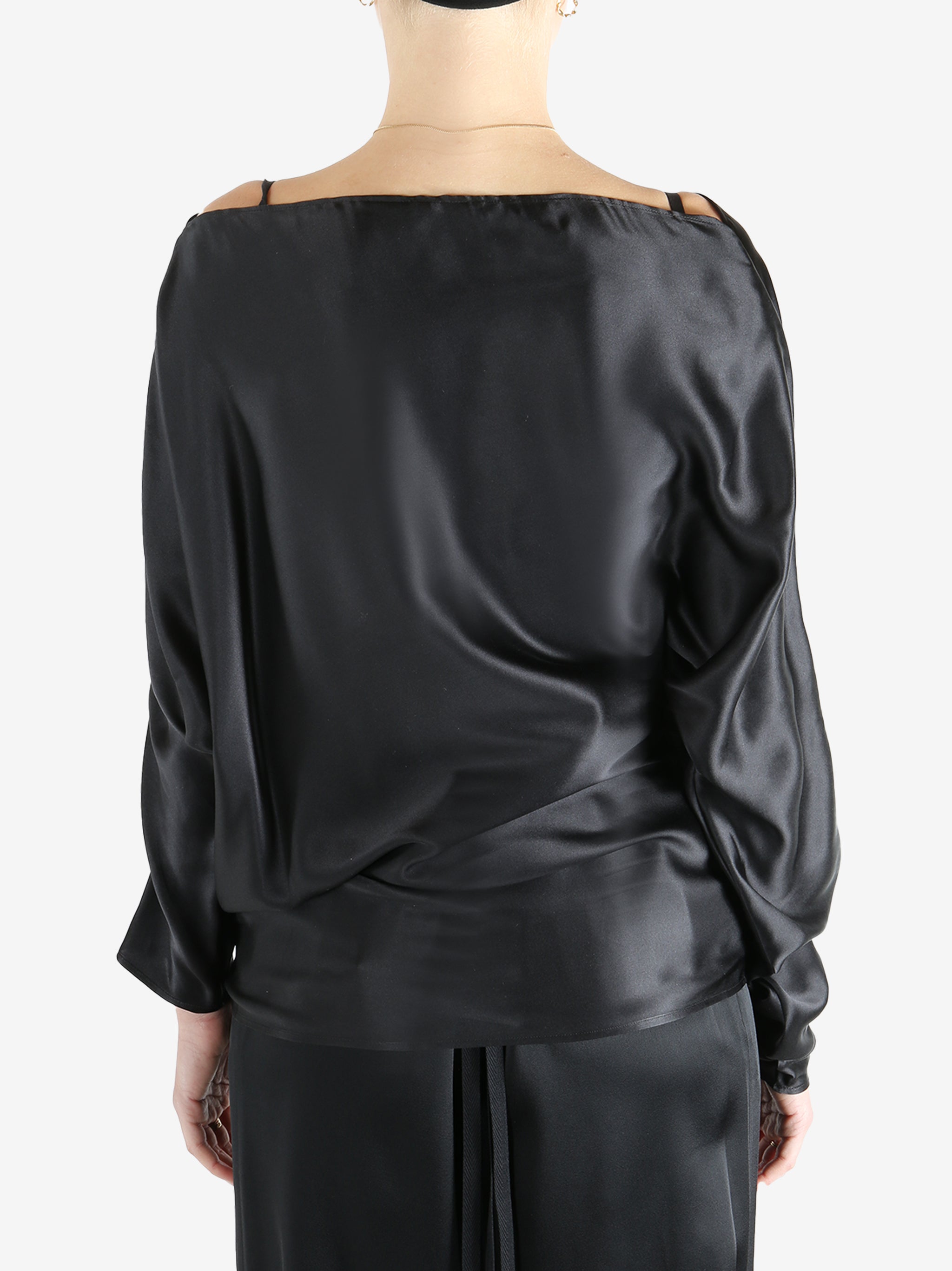 Black top worn by a person, showing the top's fit