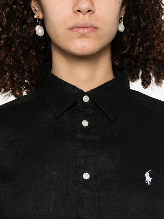 black shirt worn by a person, showing the shirt's fit