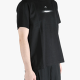 Black t-shirt worn by a person, showing the t-shirt's fit