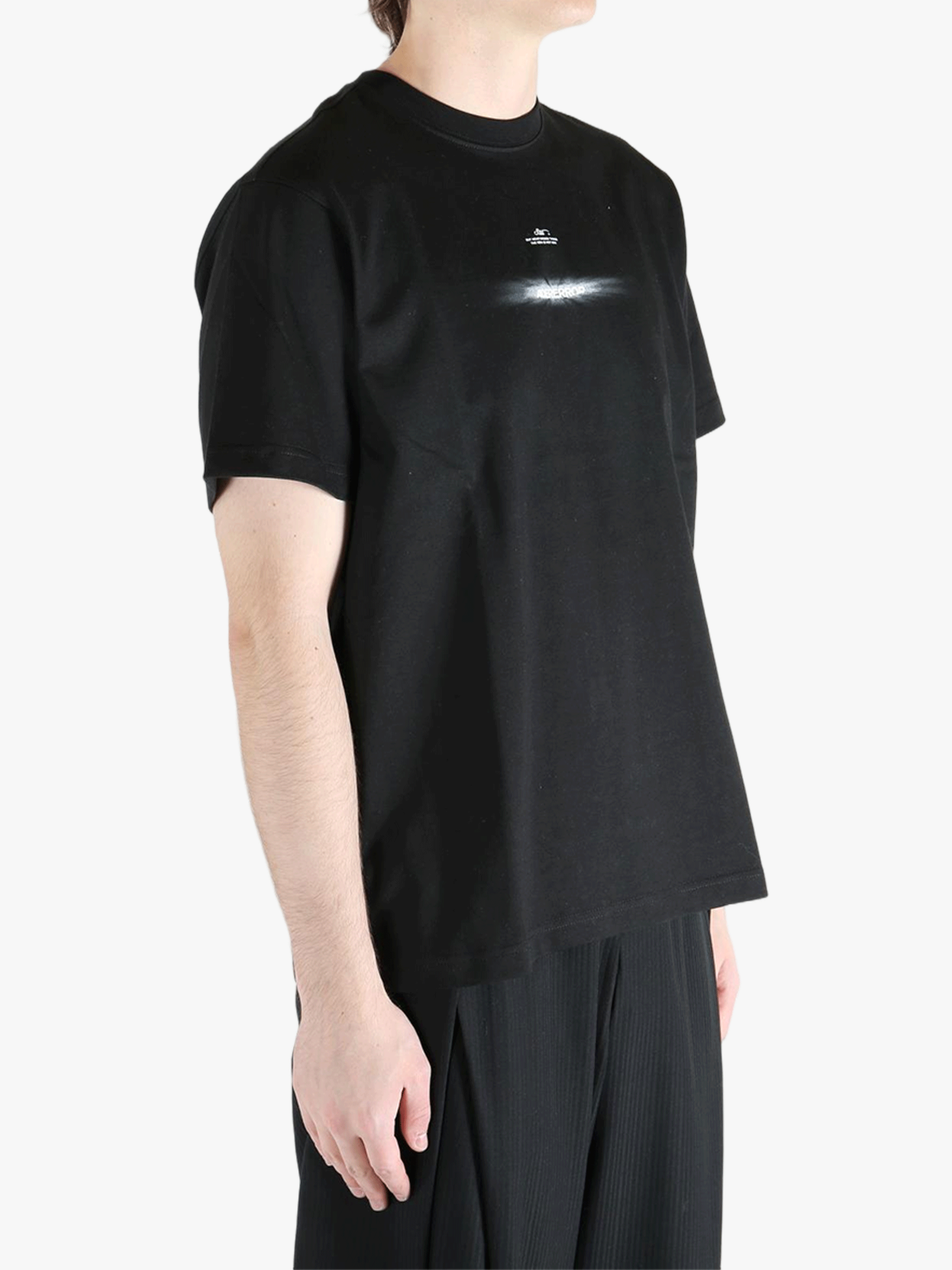 Black t-shirt worn by a person, showing the t-shirt's fit