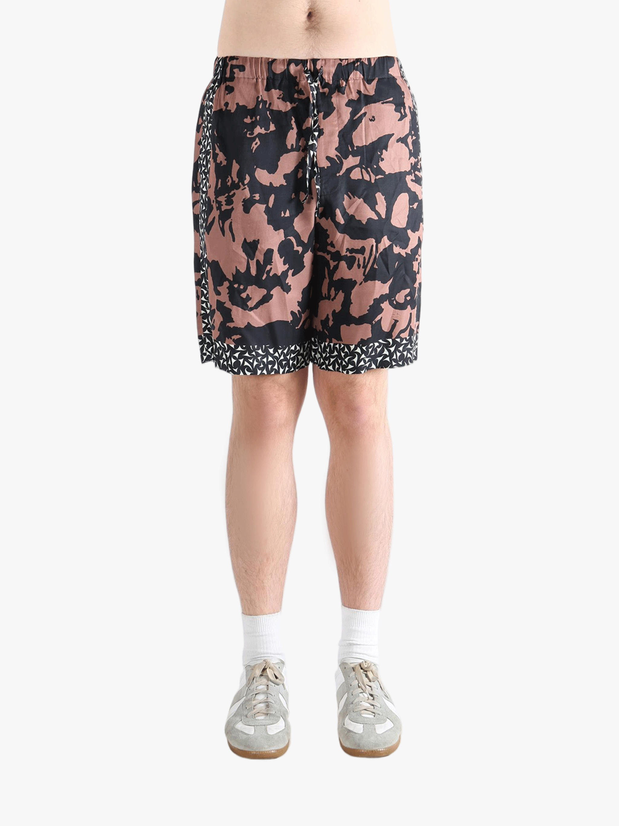 Pink shorts worn by a person, showing the shorts fit 