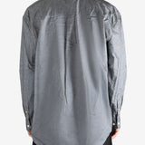 Grey shirt worn by a person, showing the shirt's fit