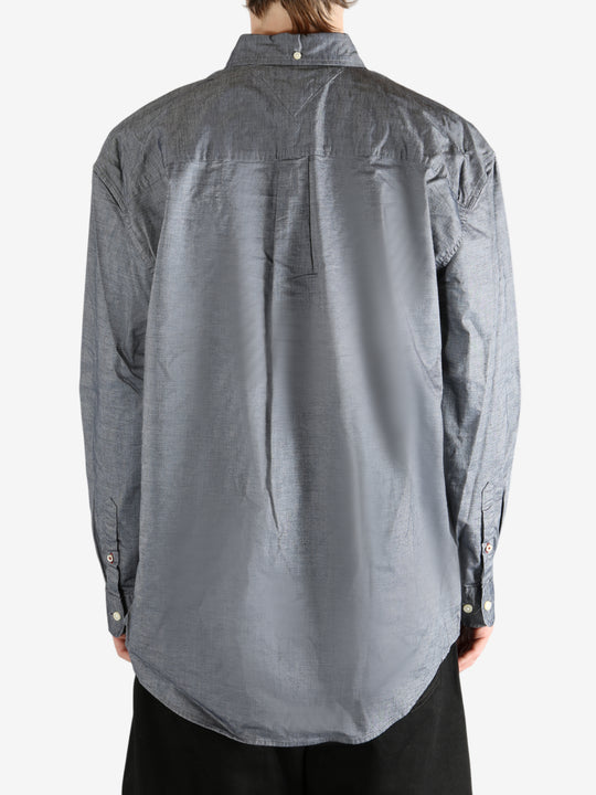 Grey shirt worn by a person, showing the shirt's fit