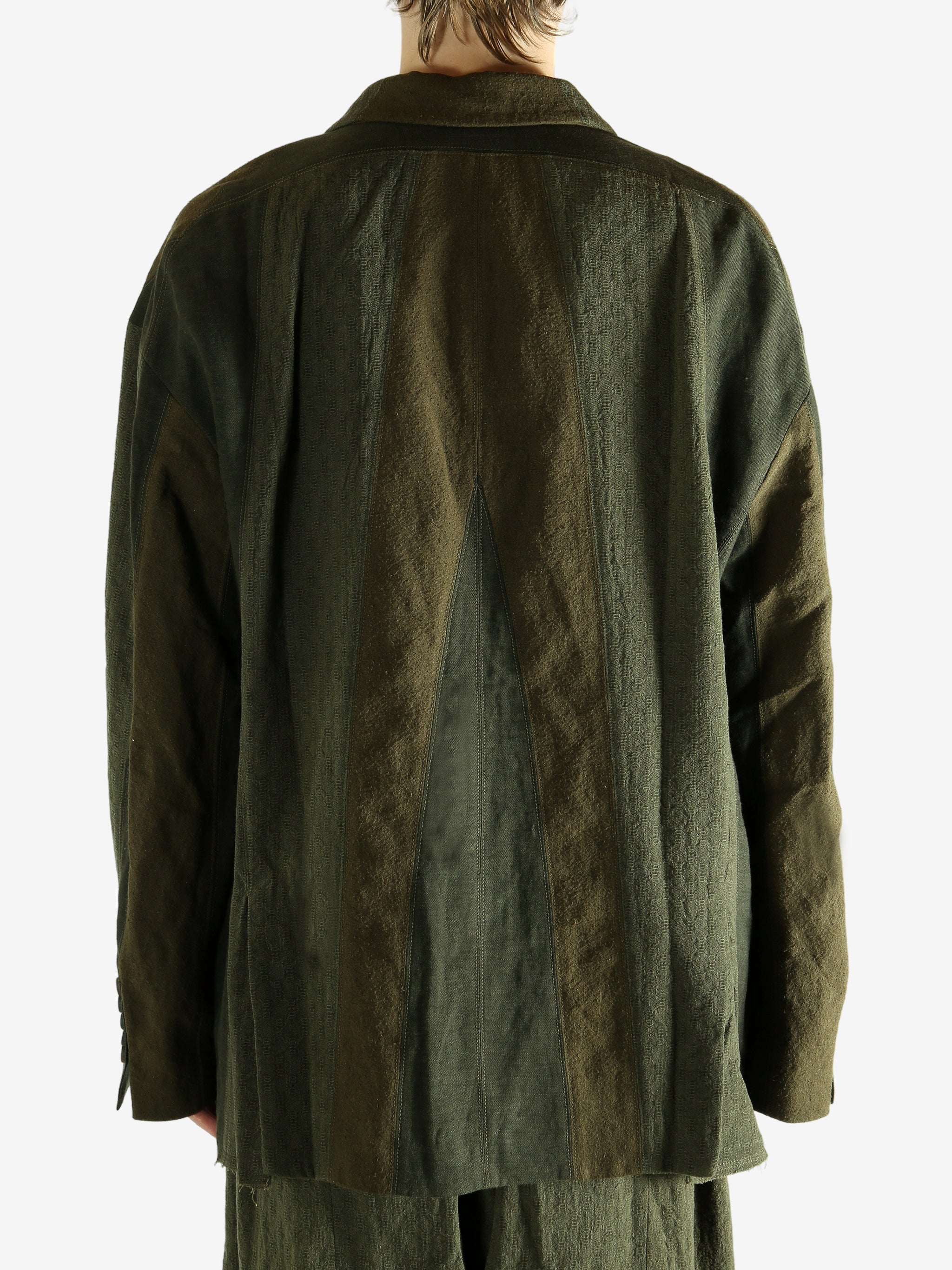 Green blazer worn by a person, showing the blazer's fit