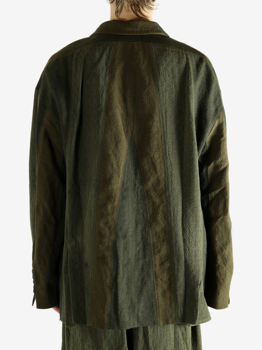 Green blazer worn by a person, showing the blazer's fit