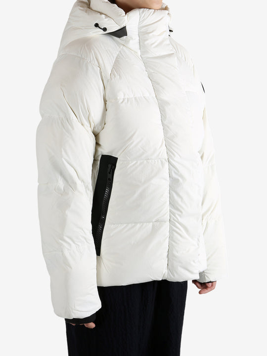 White coat worn by a person, showing the coat's fit