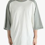 White t-shirt worn by a person, showing the shirt's fit