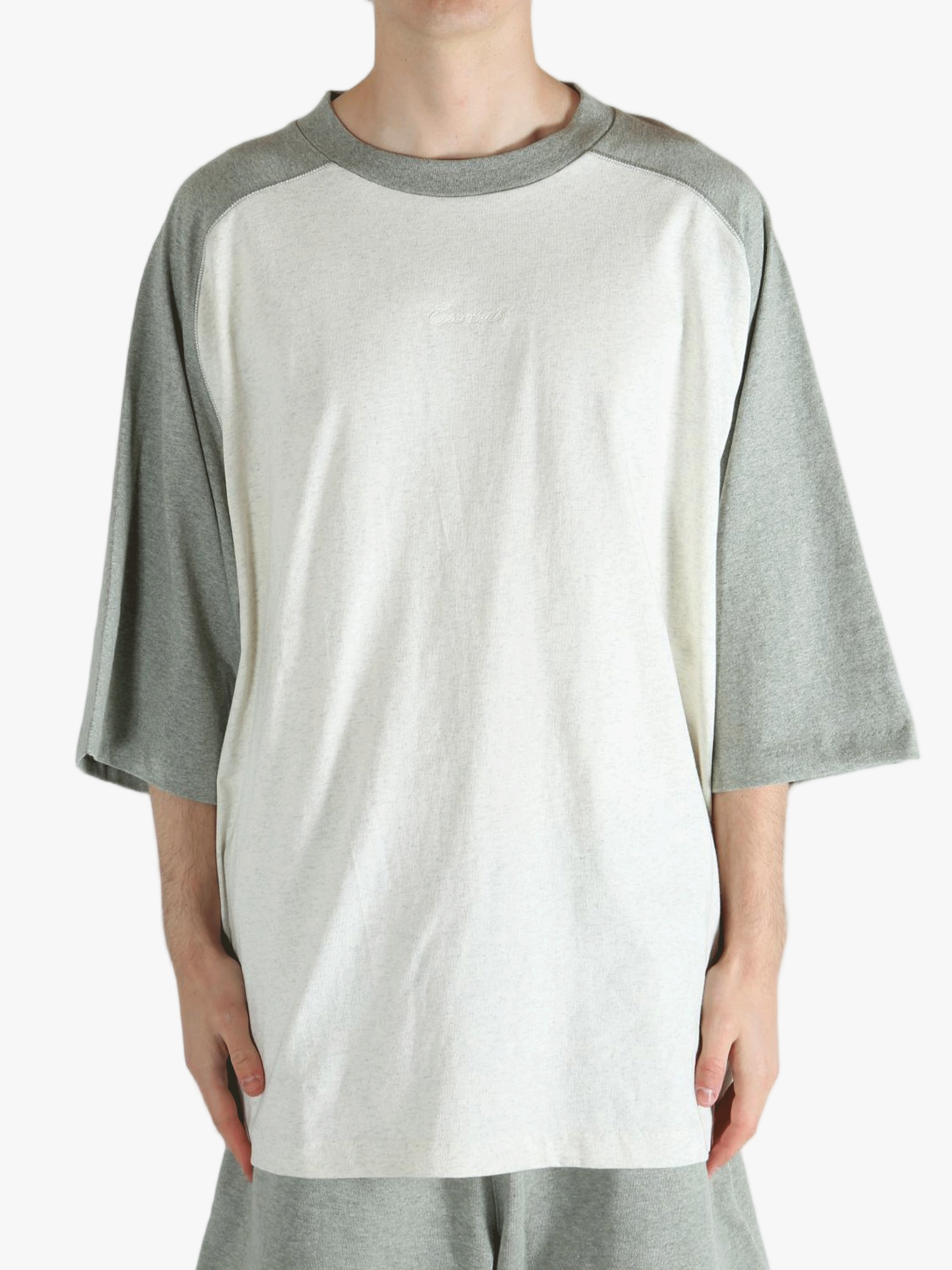 White t-shirt worn by a person, showing the shirt's fit